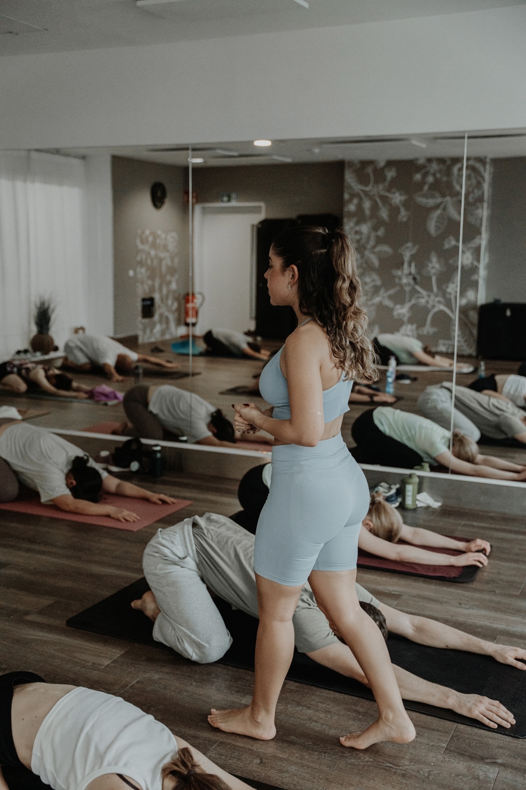 Shideh holding space while members rest on their mats